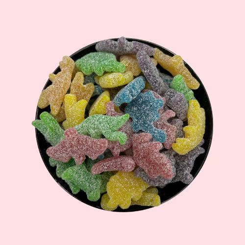 groen-rode-gele dino vormige snoep in zwart bakje