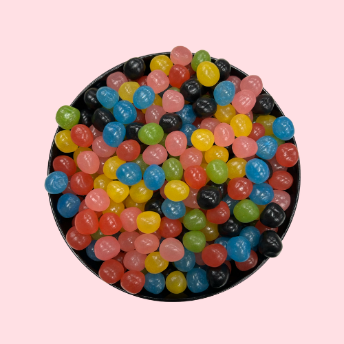 Blauw-groene-zwarte-gele-roze draaibus snoepjes in zwart bakje