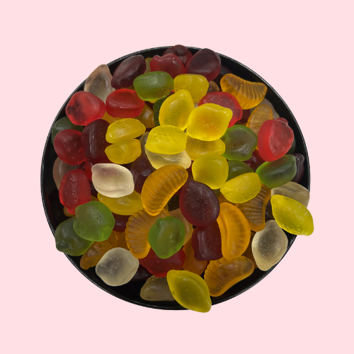 geel-oranje-rood-groen-witte fruit snoepjes suikervrij in zwart bakje