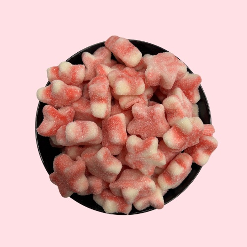 Roze en witte gesuikerde Twist Stars snoepjes in zwart bakje