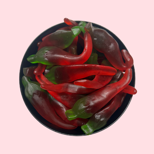 Rode en groene licht pittige chili peper snoepjes in zwart bakje