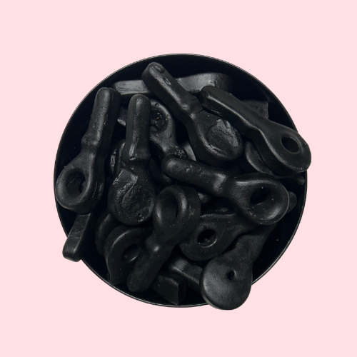 Zwarte Drop Spenen snoepjes in zwart bakje