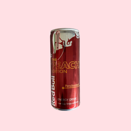 Rood Red Bull Peach Edition blikje met stier-logo