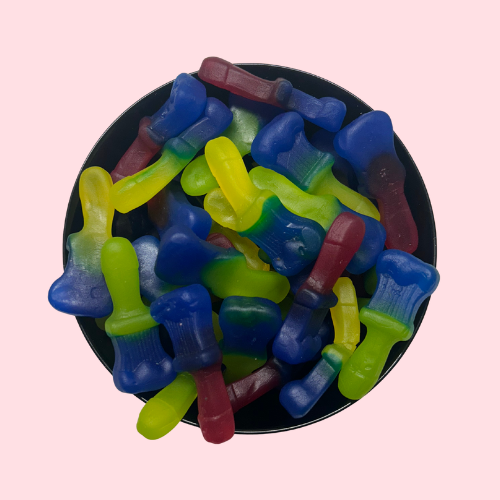 Tongkwastsnoep geel, blauw, rood en groen in zwart bakje