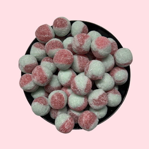 Zure watermeloenkogels roze en groen in zwart bakje